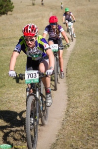 Action shot of Cassie in second during her first lap at Peaceful Valley Invitational with her teammate coming up behind.